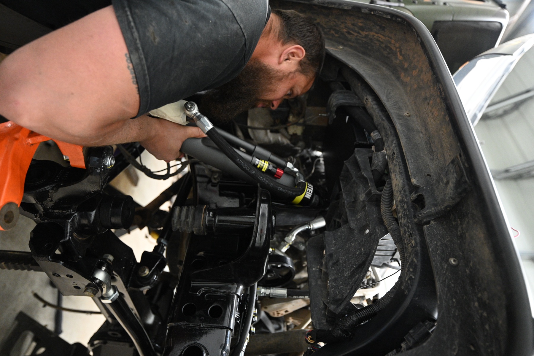 Rob installing Bilstein suspension on a customer Jeep in the ABO shop